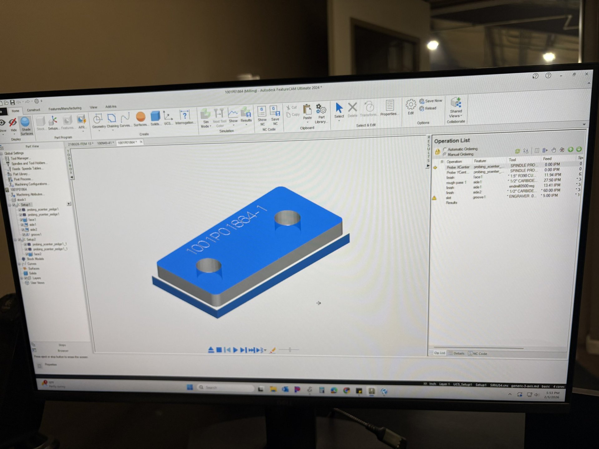 CAD software displaying a blue rectangular 3D model with mounting holes on a computer screen